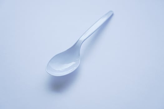 White disposable plastic spoon used for eating photo