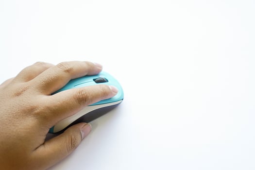human hand on a light blue wireless mouse photo