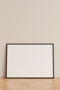 Clean and minimalist front view horizontal black photo or poster frame mockup leaning against wall on wooden floor. 3d rendering.