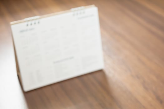 calendar page on wood floor blurred for background photo