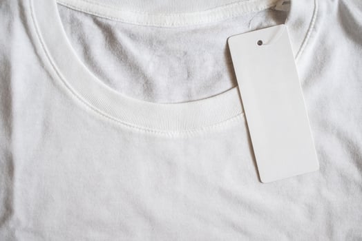Blank price tag label on white t-shirt photo