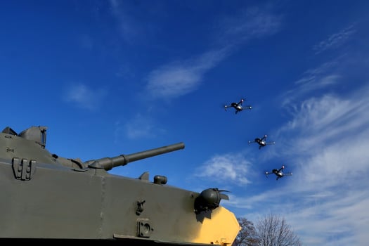 tank aims a gun at the drone. Fighting drones and quadrocopters photo