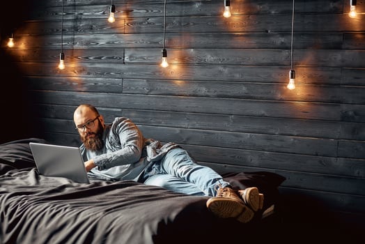 lifestyle successful freelancer man with beard achieves new goal with laptop in loft interior photo