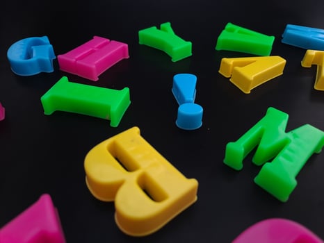 Close up of colorful alphabets on black background perfect for children's education photo