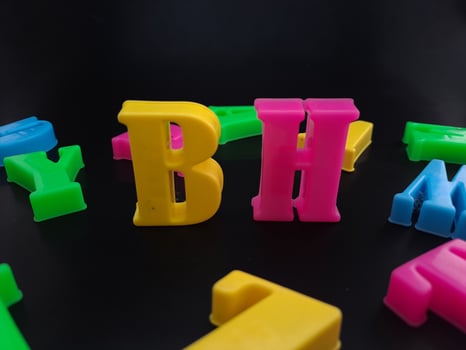 Close up of colorful alphabets on black background perfect for children's education photo