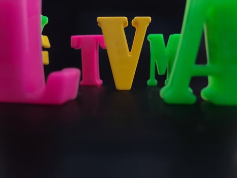 Close up of colorful alphabets on black background perfect for children's education photo