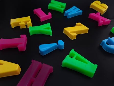 Close up of colorful alphabets on black background perfect for children's education photo