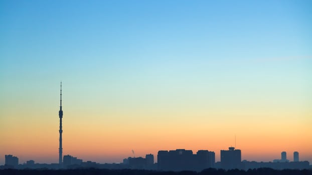 clear blue and yellow dawning sky over city photo