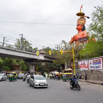 New Delhi, India - June 21, 2022 - Big statue of Lord Hanuman near the delhi metro bridge situated near Karol Bagh, Delhi, India, Lord Hanuman statue touching sky photo