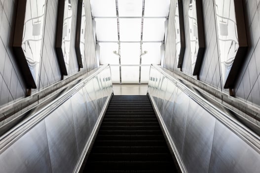 Looking up a moving escalator at subway station photo