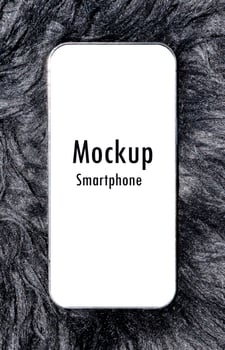 Smartphone with mockup white screen and clipping path on black wool rug photo