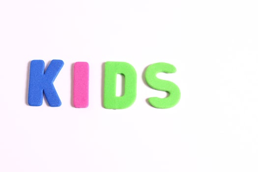 Kids lettering word, on white photo