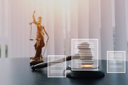 Justice and law concept.Male judge in a courtroom with the gavel, working with, computer and docking keyboard, eyeglasses, on table in morning light photo