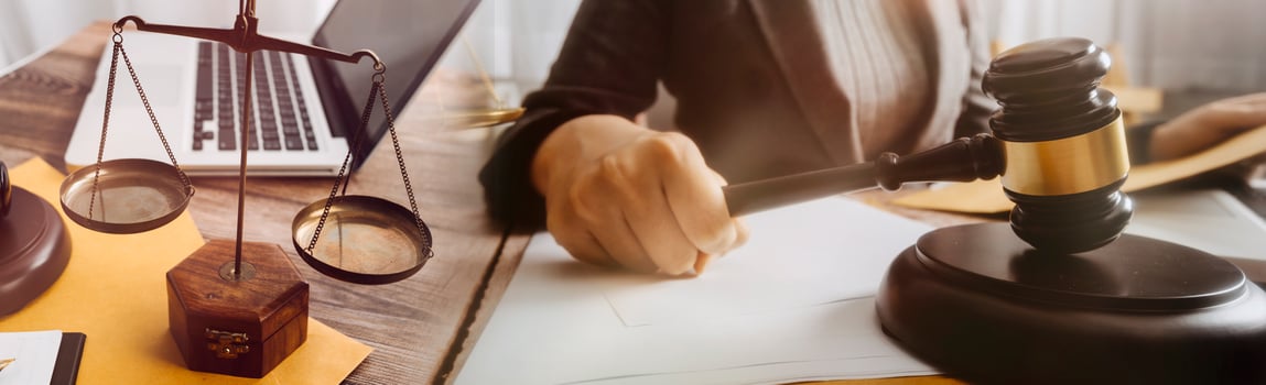 Male lawyer working with contract papers and wooden gavel on tabel in courtroom. justice and law ,attorney, court judge, concept. photo