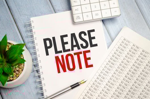 please note word on notepad with glasses and chart photo
