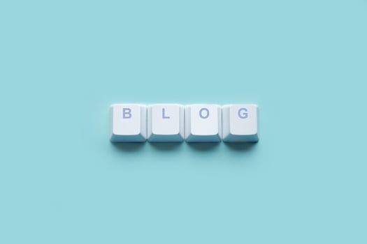 Word BLOG written on computer keyboard keys isolated on a turquoise photo