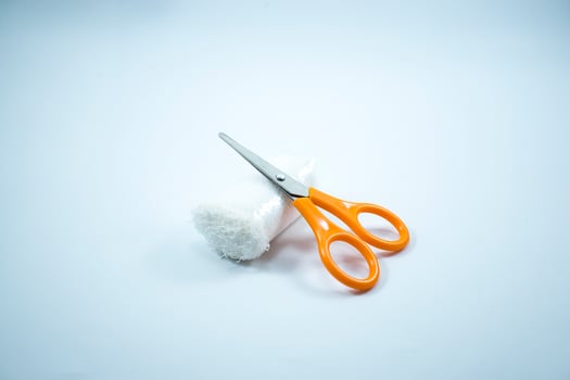 gauze rolls and mini scissors are usually used for first aid bandages photo