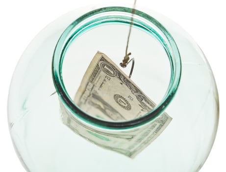top view of catching last dollar from glass jar photo