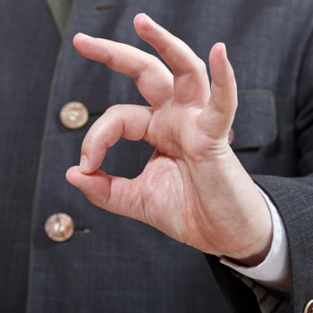 businessman shows OK sign close up photo