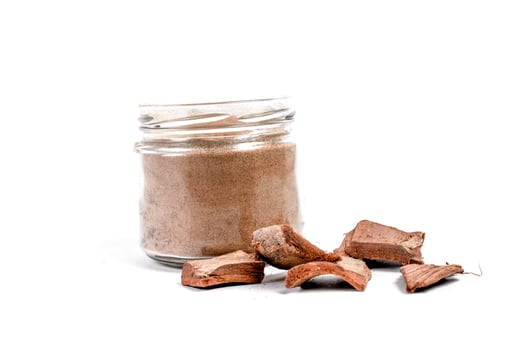 Dry arjun chal powder or Terminalia arjuna ayurvedic herb on white background photo