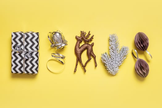 Festive minimal creative christmas composition with gifts and decorations flat lay on colored background photo