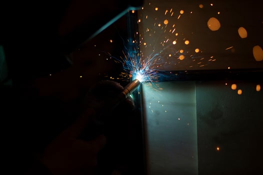 Welding work. Sparks from welding metal. Production details. photo