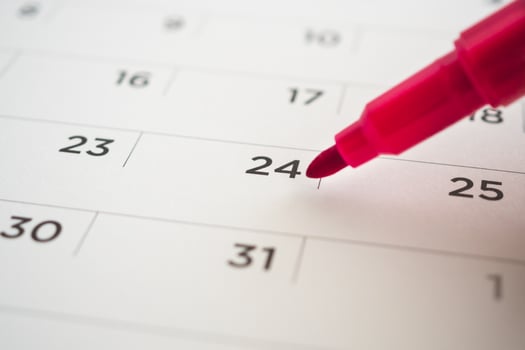 calendar page with red pen close up photo