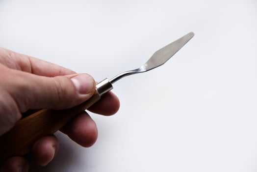 Palette knife No. 4 artistic iron with a wooden handle on a white background. An artist's paint tool. photo