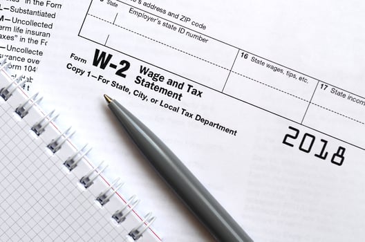 The pen and notebook on the tax form W-2 Wage and Tax Statement. The time to pay taxes photo