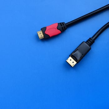 Audio video HDMI computer cable plug and 20-pin male DisplayPort gold plated connector for a flawless connection on a blue background photo