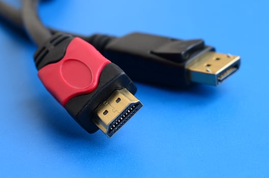 Audio video HDMI computer cable plug and 20-pin male DisplayPort gold plated connector for a flawless connection on a blue background photo