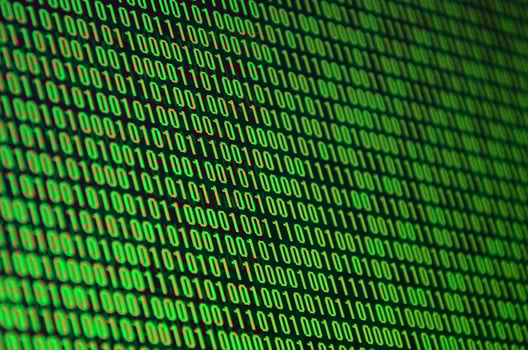 An image of a binary code made up of a set of green digits on a black background photo