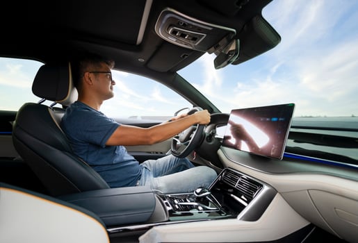 An Asian man drives from town to go on a summer vacation. Happy Asian man in casual wear and beautiful new driving glasses. photo