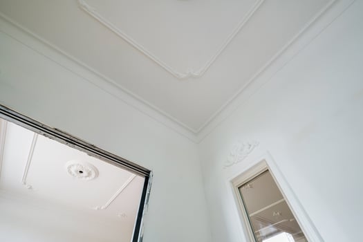 corner of ceiling cornice with intricate crown molding. photo