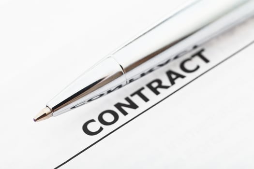 word contract and silver pen photo