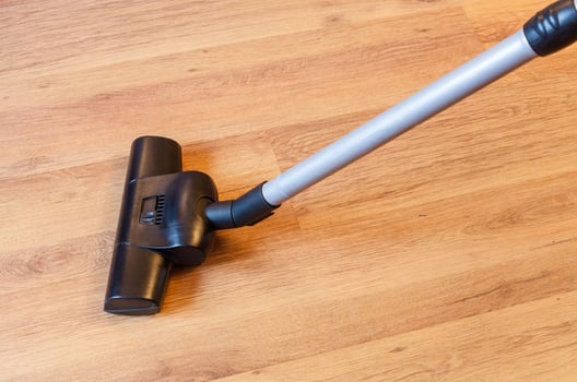 vacuuming of parquet floor by vacuum cleaner photo