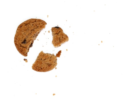 round chocolate chip cookie with crumbs isolated on white background photo