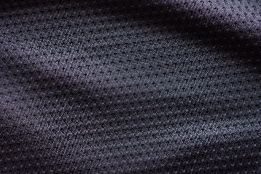 Black fabric sport clothing football jersey with air mesh texture background photo