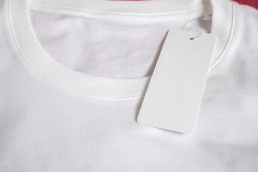 Blank price tag label on white t-shirt photo