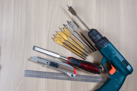 Different tools on a wooden background. drill, Wood drill, concrete drill bit photo