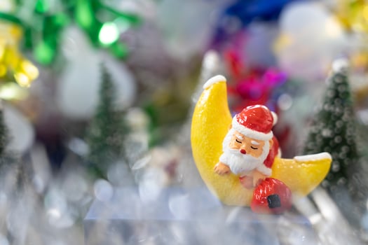 Santa sleep in the Croissant moon in front of Christmas trees waiting for funny festival Christmas and Happy New Year to created greeting card, happiness and funny concept. photo
