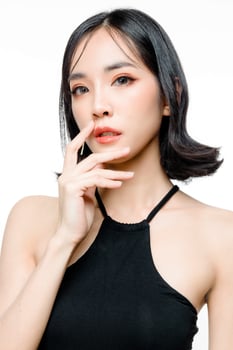 Fashionable asian woman short hair with Perfect body. Cute female model with natural makeup and sparkling eyes on white isolated background. Facial treatment, Cosmetology, beauty Concept. photo