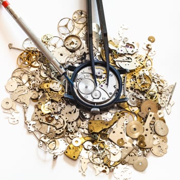 tools above watch on heap of spare parts photo