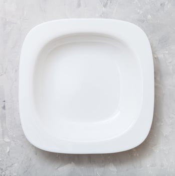 top view square white deep plate on concrete board photo