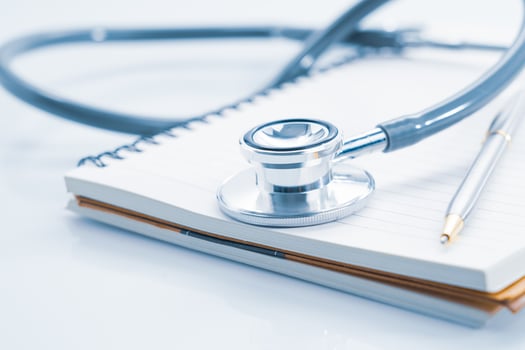 Stethoscope on blank notepad photo