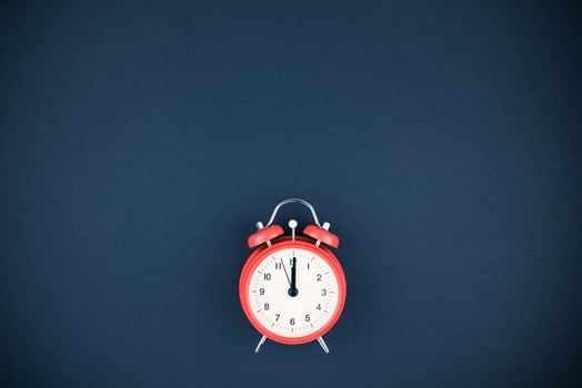 Red vintage alarm clock on dark background photo