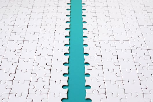 The blue path is laid on the platform of a white folded jigsaw puzzle. Texture image with copy space for text photo