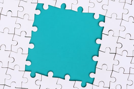 Framing in the form of a rectangle, made of a white jigsaw puzzle around the blue space photo