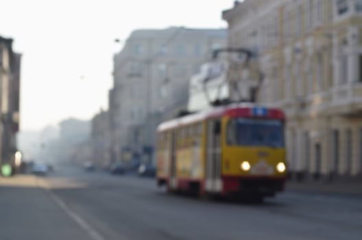 Blurred landscape of highway with cars and tram in foggy morning photo