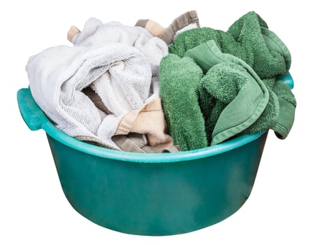 Round green plastic wash basin with dirty clothes photo